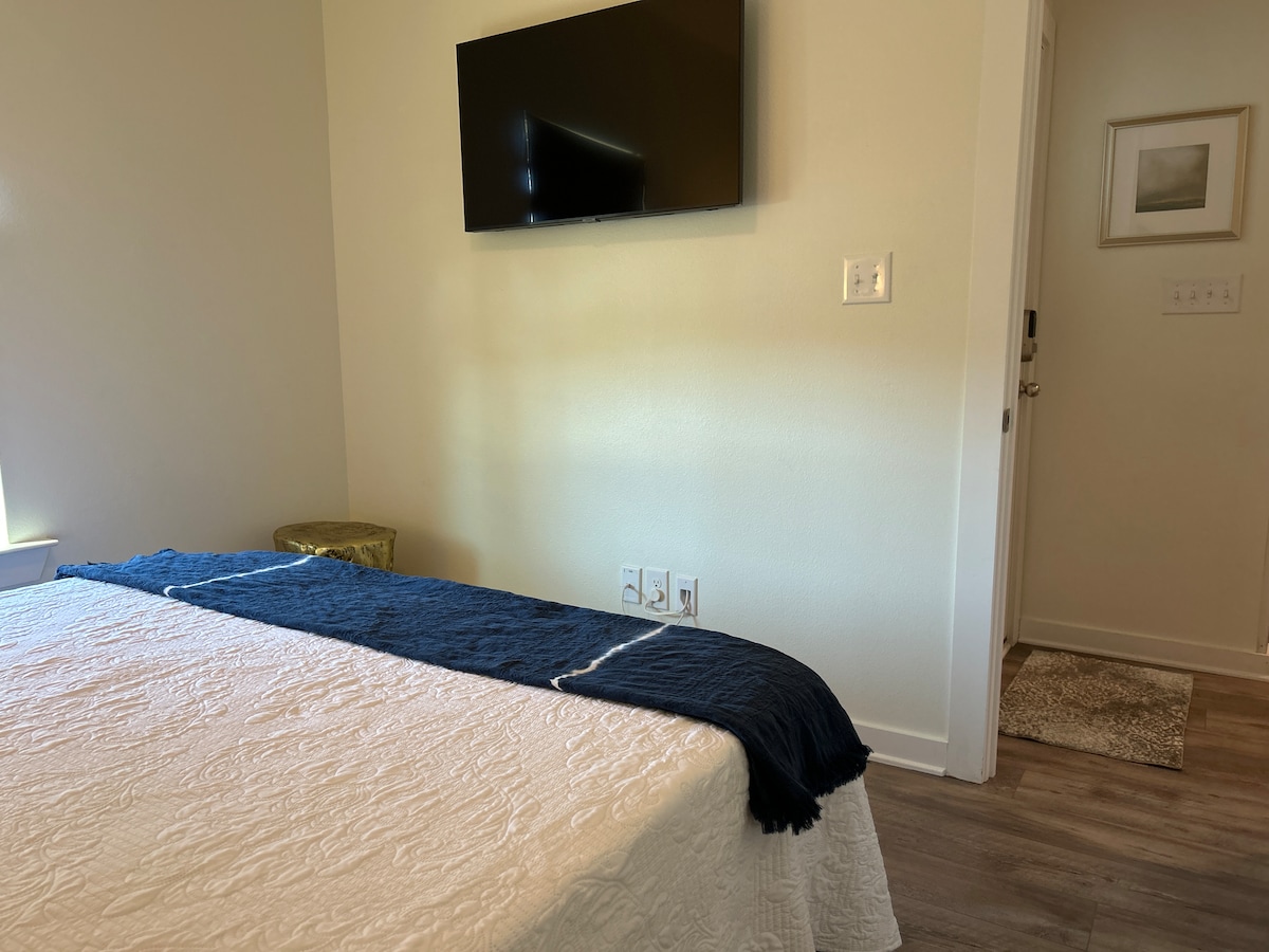 Second guest bedroom with modern decor and Samsung Smart TV at Auer House
