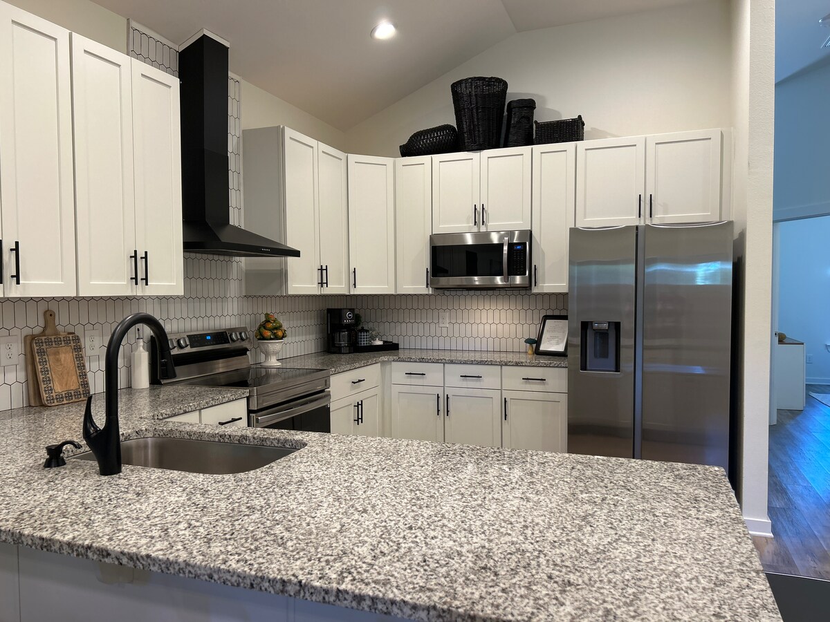 Kitchen counter seating for six with coffee maker and stocked cabinets