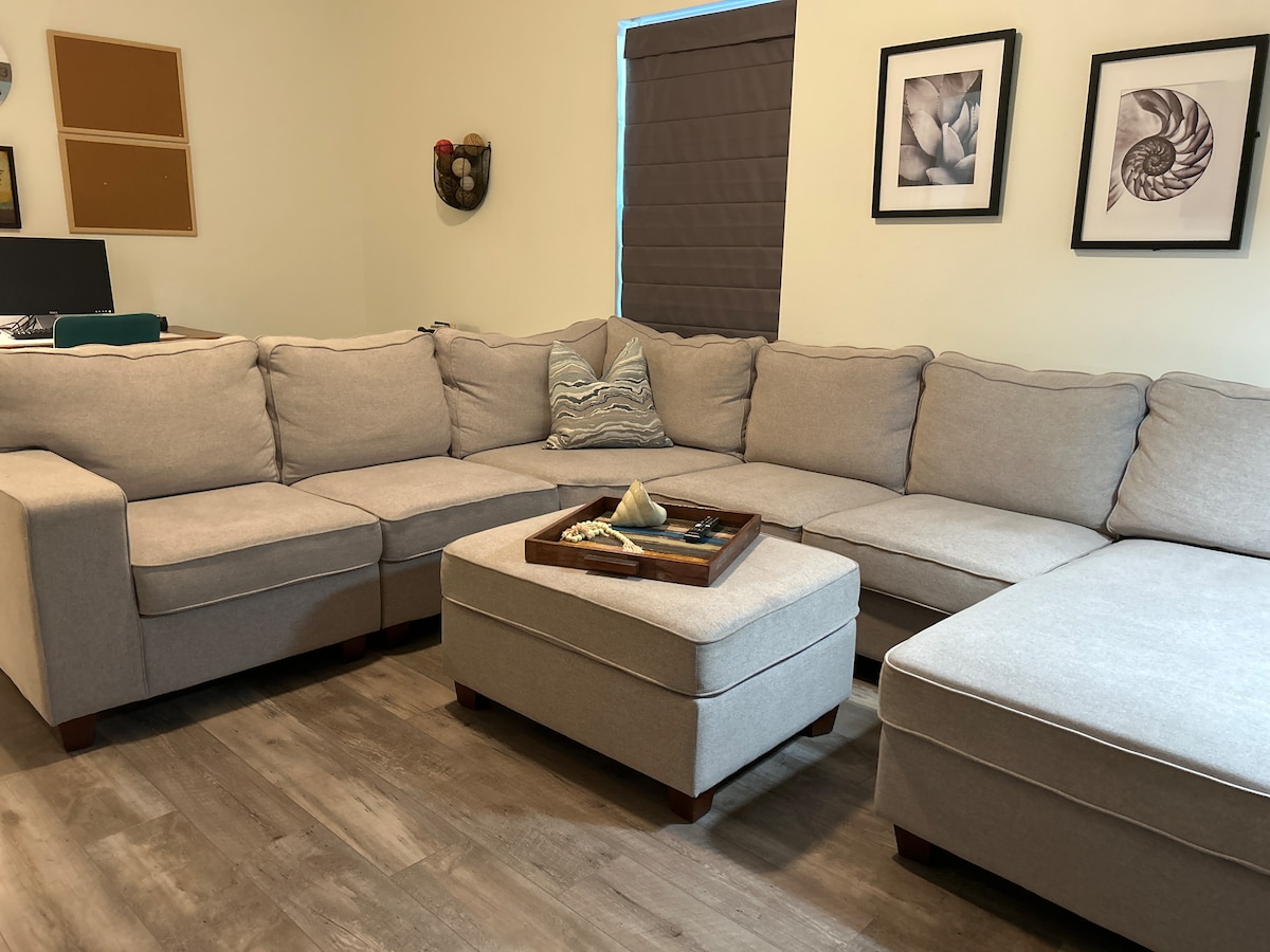 Spacious living room with sectional sofa and 58-inch Samsung Smart TV at Auer House