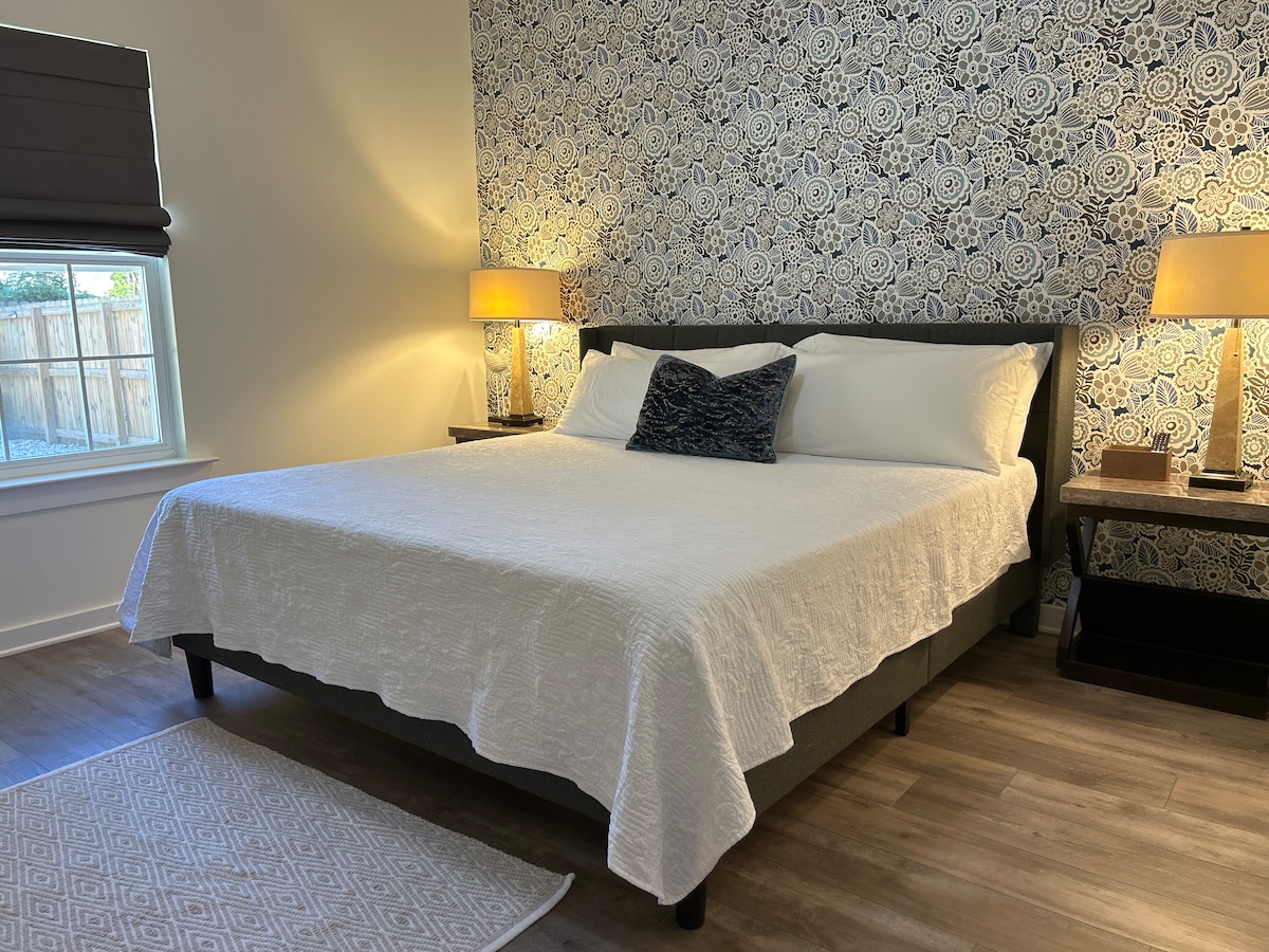 Primary suite bedroom detail with modern decor at Auer House downtown Pensacola